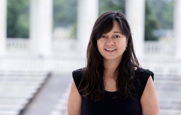 A woman in front of a set of steps.